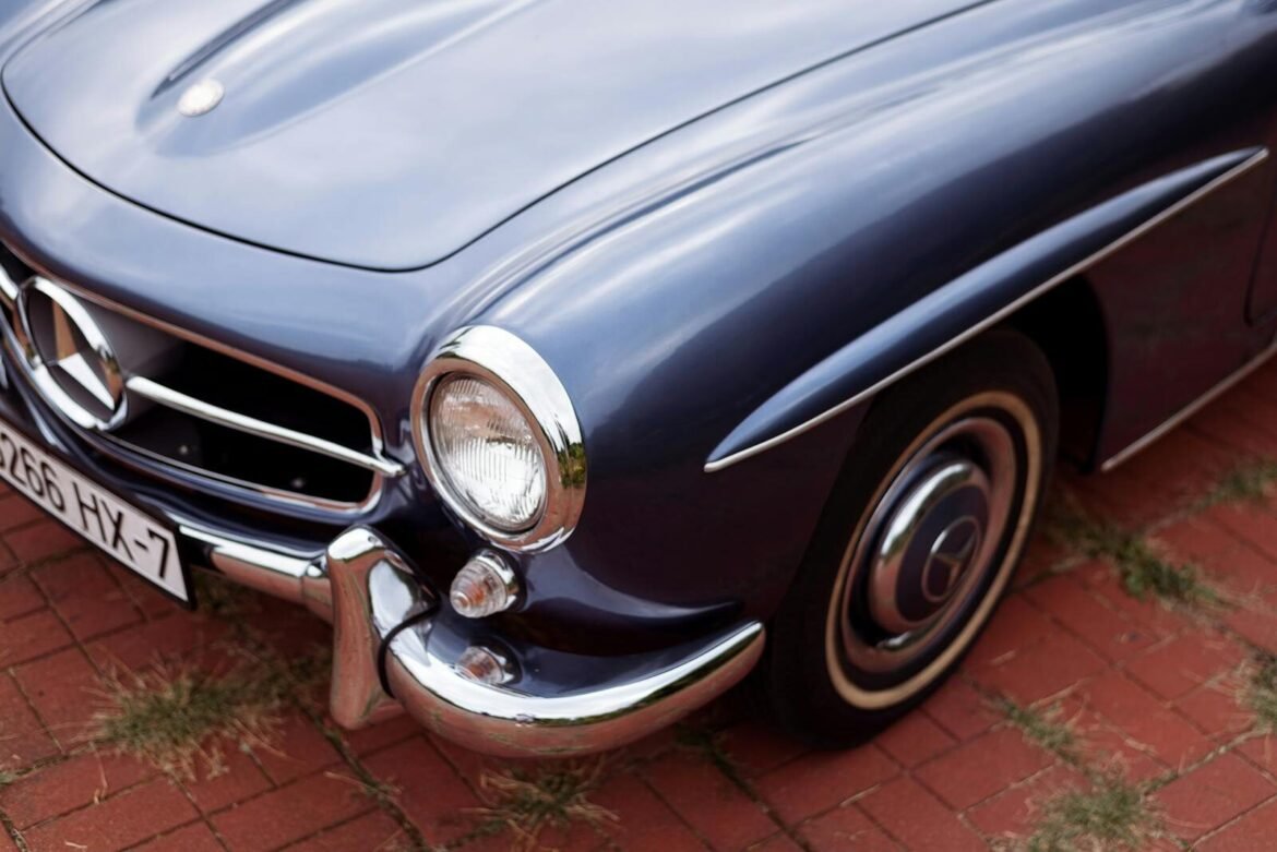 Detailed close-up shot of a classic Mercedes vintage car showcasing its sleek chrome elements and headlight.